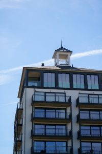 A contemporary apartment building against a clear blue sky in Cadzand, Zeeland.